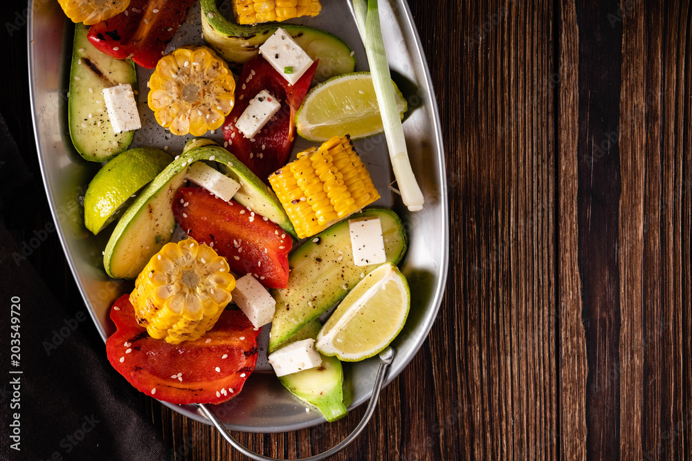 Grilled vegetables, corn cobs, zucchini, red pepper.