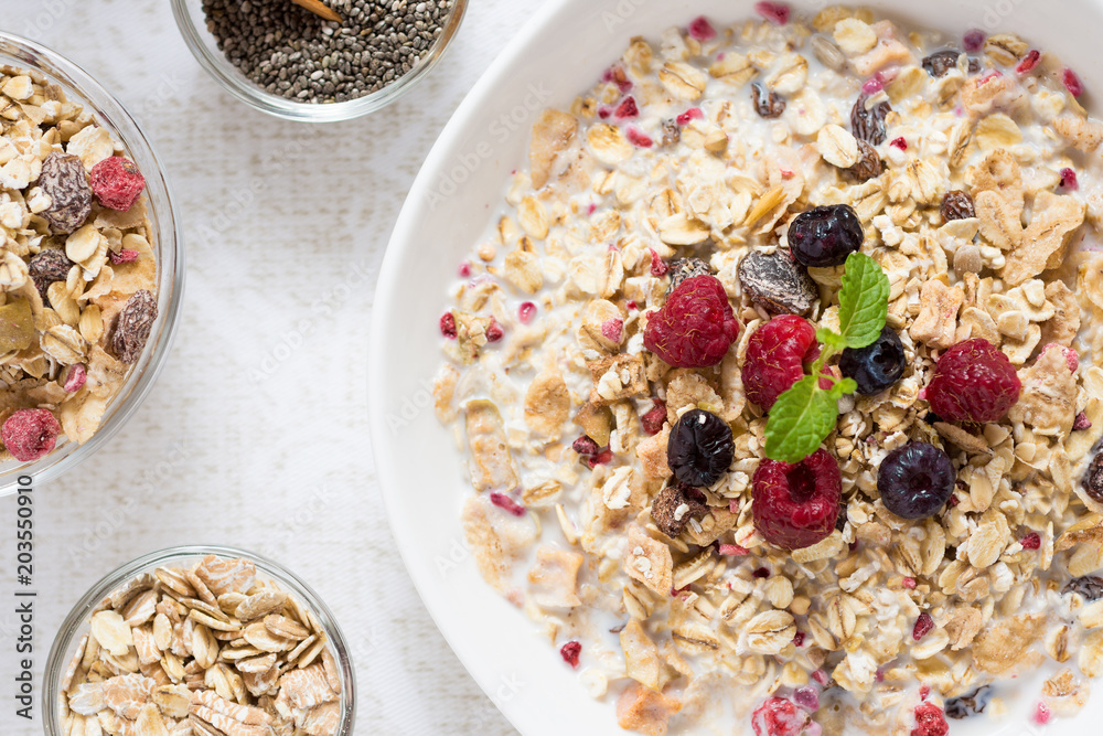 Muesli With Milk, Chia Seeds, Berries and Cinnamon with Freshly Squeezed Orange Juice Muesli With Milk, Chia Seeds, Berries and Cinnamon with Freshly Squeezed Orange Juice
