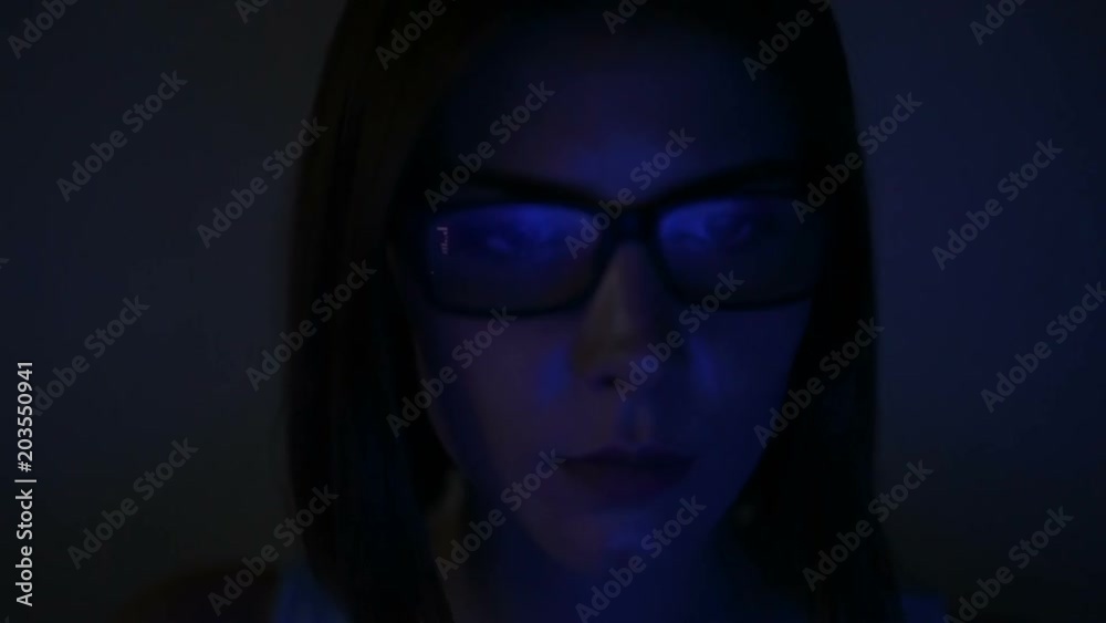 Portrait of woman in glasses working in the web, serfing. Blue reflection in glasses from laptop. Portrait of woman in glasses working in the web, serfing. Blue reflection in glasses from laptop.