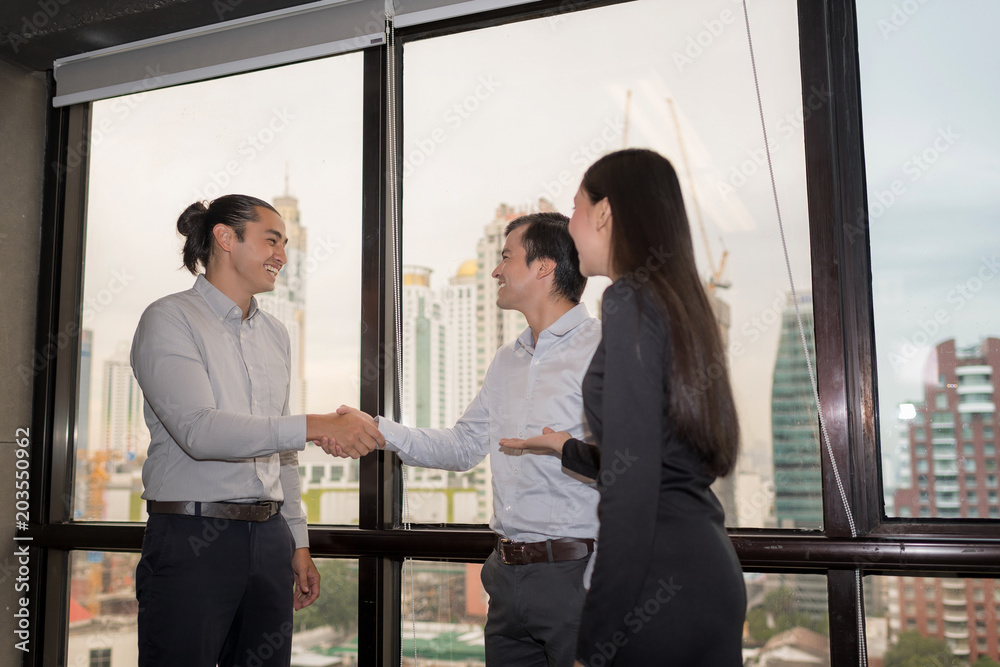 Business partners shaking hand after complete a deal. Business people handshaking.Corporation Organization Success Teamwork Concept. Business partners shaking hand after complete a deal. Business people handshaking.Corporation Organization Success Teamwork Concept.