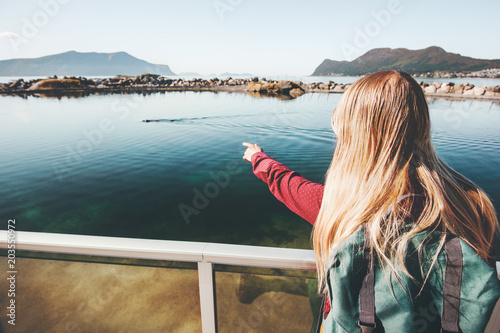 Woman tourist hand showing at seal in ocean Travel Lifestyle sightseeing concept adventure weekend vacations outdoor
