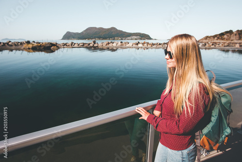 Young pretty woman walking at seaside alone Traveling lifestyle concept blonde girl with backpack weekend vacations outdoor