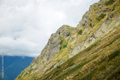 Photo of mountain slopes with vegetation and cloudy sky © nuclear_lily