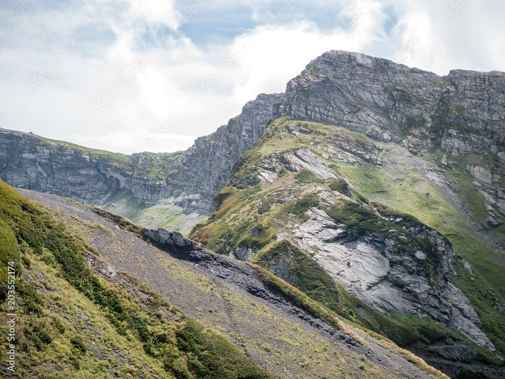 Fototapeta premium Photo of mountain slopes with vegetation and cloudy sky