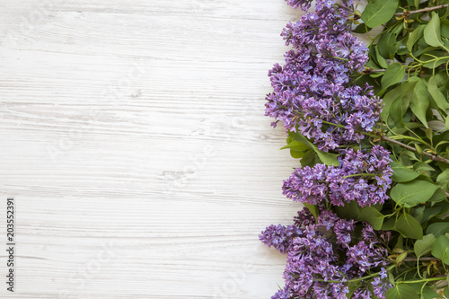 A bouquet of lilac flowers on a white wooden background. Mothers Day. Copy space. From above  flat lay.