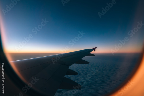  Adventure  travel  transport concept. View from plane window at sky with  clouds and wing 