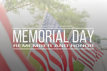 Text Memorial Day remember and honor on long row of lawn American Flags background. Green grass yard USA flags blow in the wind. Concept of Memorial day or Veteran's day in America.