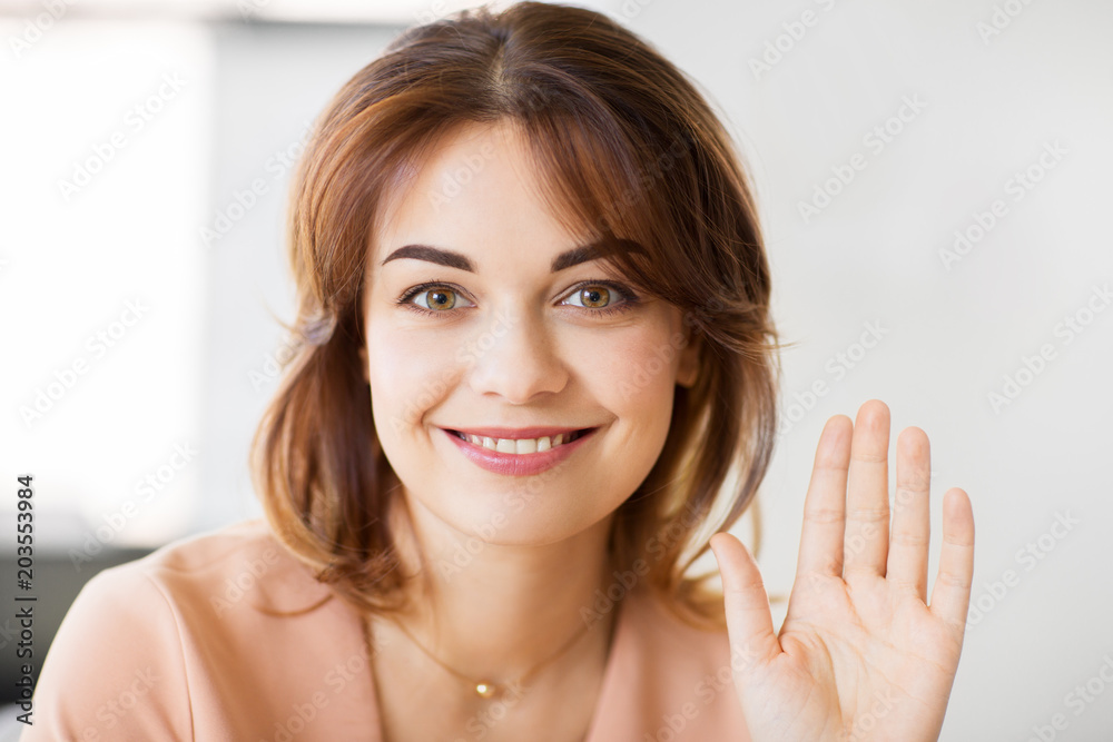 people and gesture concept - portrait of happy smiling young woman waving hand people and gesture concept - portrait of happy smiling young woman waving hand