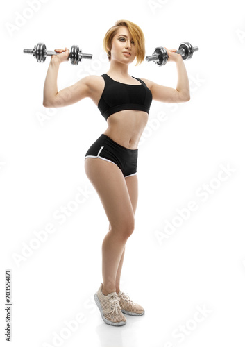 Portrait of beautiful charming sporty young woman with dumbbells on white