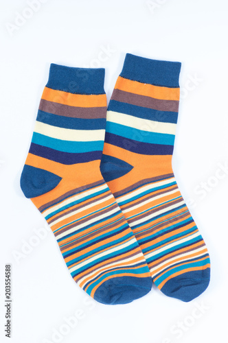 A pair of striped socks. Stripes color: mustard, turquoise, blue and white . 