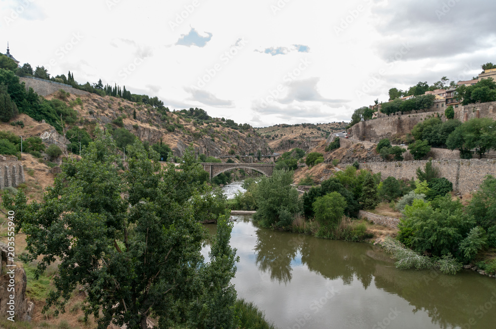 Landscape of Toledo, Spain, with the river Tajo and a dramatic sky with clouds. Landscape of Toledo, Spain, with the river Tajo and a dramatic sky with clouds.