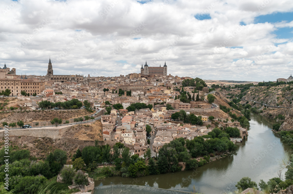Landscape of Toledo, Spain, with Alcazar, the river Tajo and a dramatic sky with clouds. 