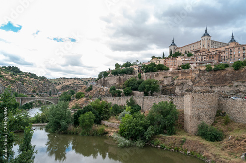 Landscape of Toledo, Spain, with Alcazar, the river Tajo and a dramatic sky with clouds. 