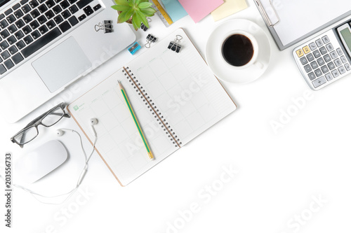 white office desk table with laptop and other supplies