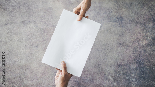 Hands of people passing document