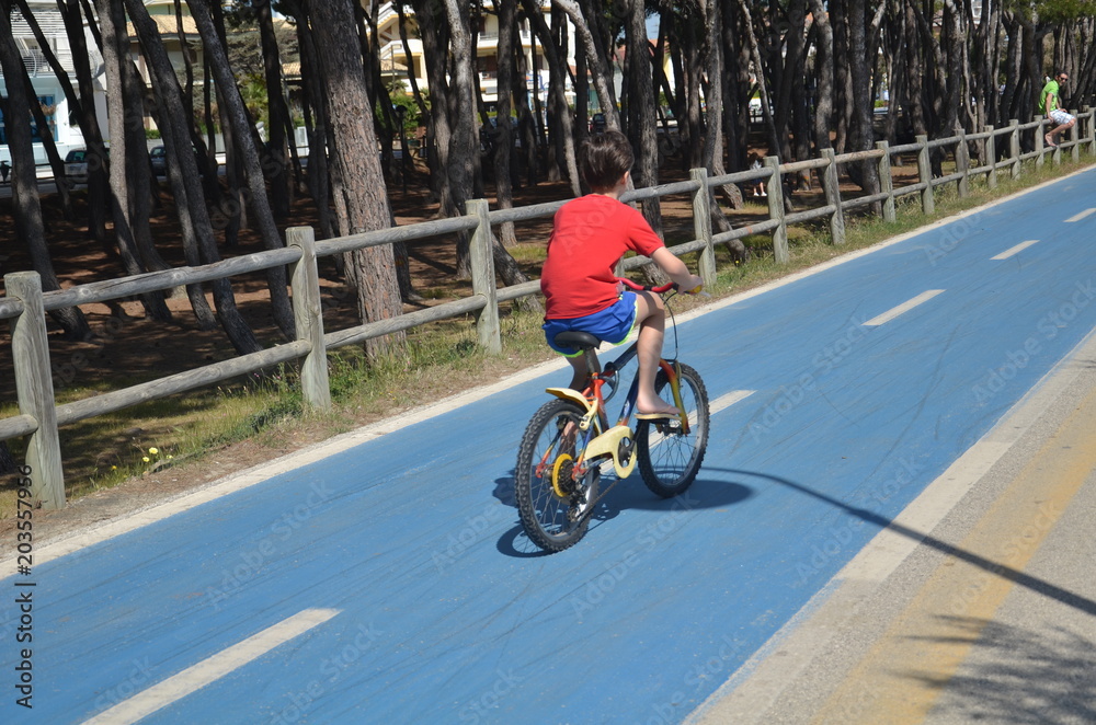 child cycling on bike path