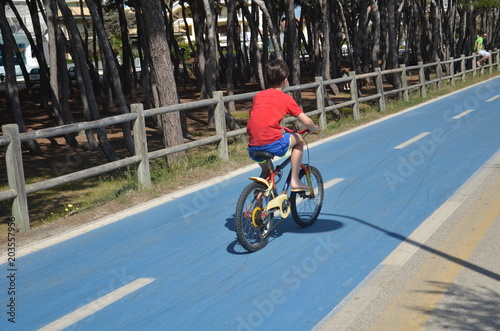 child cycling on bike path