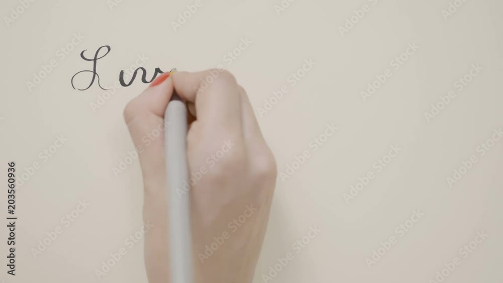 Female hands writing inspirational message live each day as if your life had just begun with black pen on a white paper