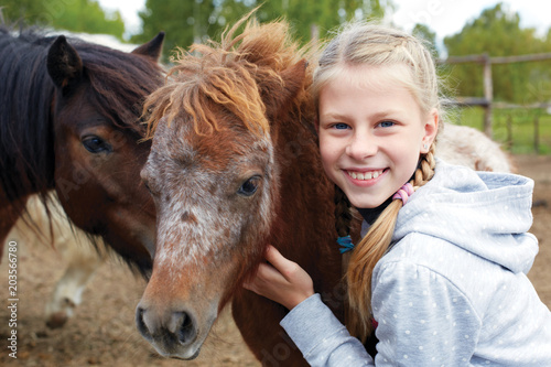 Pony and horsewoman - little girl and her best friend © natasnow