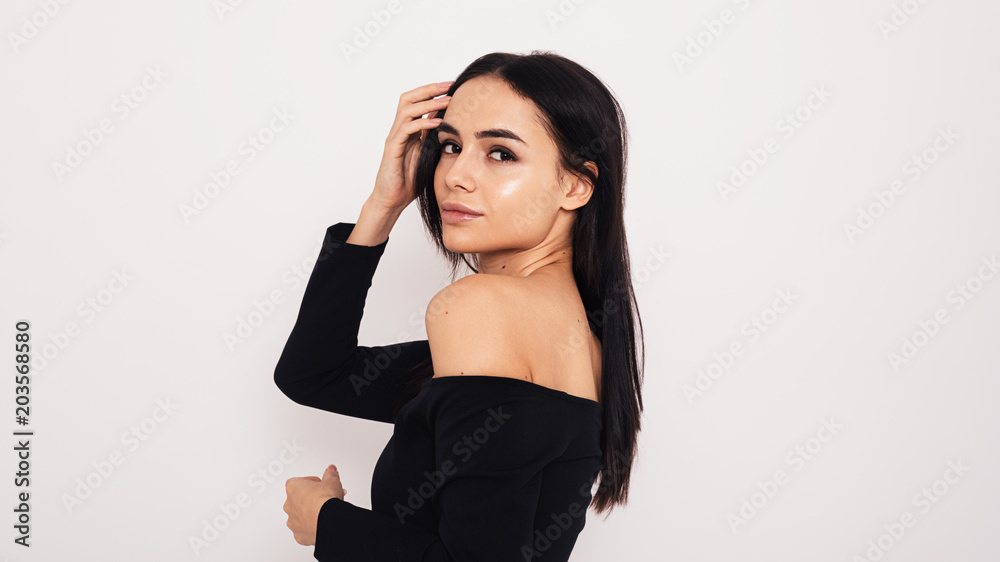 Side view of young model wearing black dress Side view of young model wearing black dress