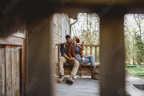young couple hipster sitting on a bench on the terrace