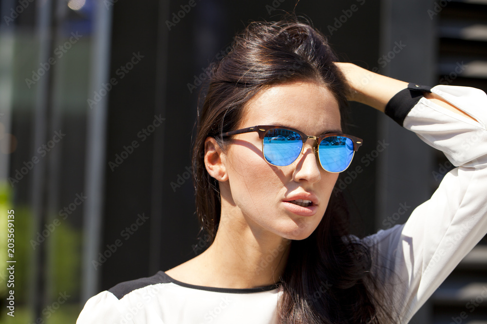 Business woman with blue mirrored sunglasses Business woman with blue mirrored sunglasses