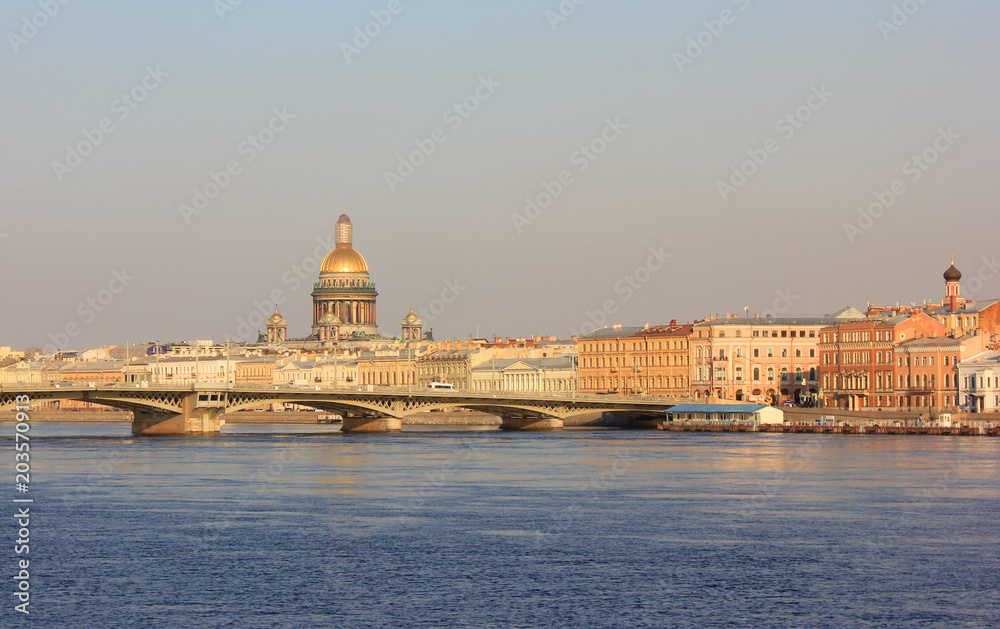 Saint Petersburg City Skyline with St. Isaac's Cathedral and Draw Bridge in Russia. Cityscape Close Up Over the River Water at Dusk Sky Background before Sunset. St. Petersburg Touristic Wallpaper.