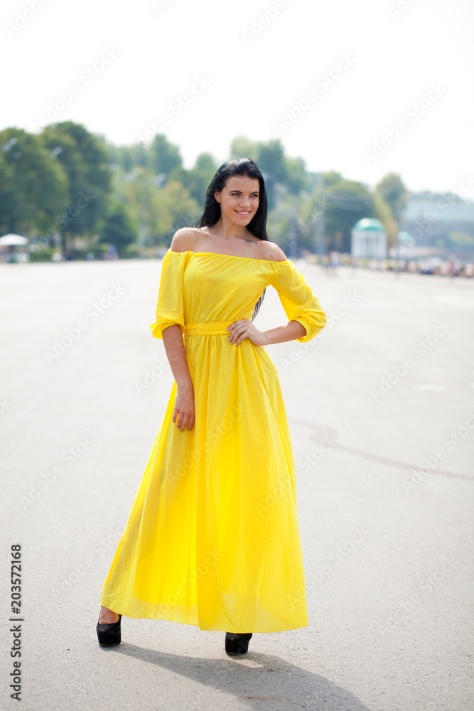 Beautiful young woman in yellow dress