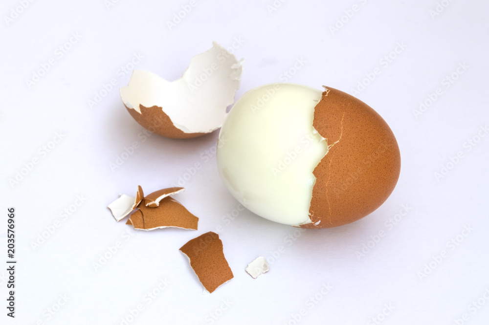 hard boiled eggs and egg shells on white background hard boiled eggs and egg shells on white background
