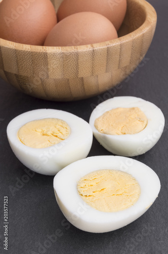 hard eggs peeled and cut in half in a bowl