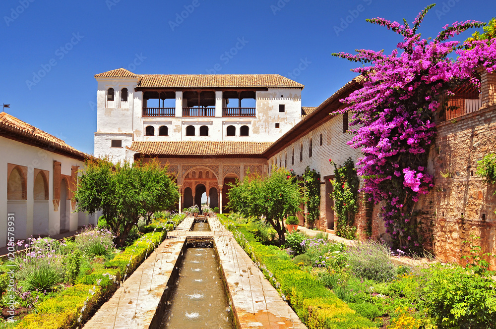 Fountain and gardens in Alhambra palace, Granada, Andalusia, Spain.