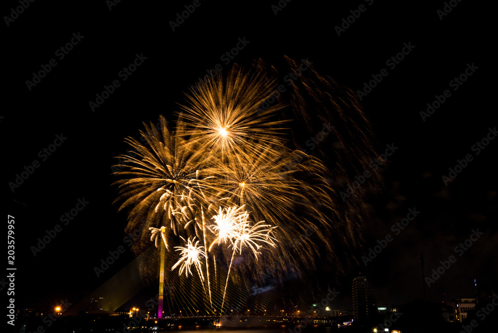 Beautiful golden firework display for celebration happy new year and merry christmas in the night sky, bangkok city, thailand