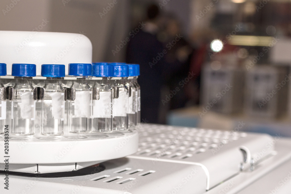 Glass vials for liquid samples. Laboratory equipment for dispensing fluid samples.