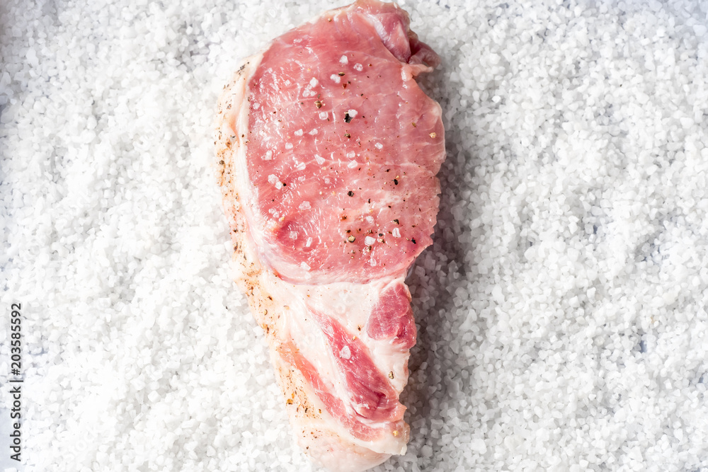 Slice steaks Raw pork chop marinated meat roll with coarse sea salt pepper and olive oil