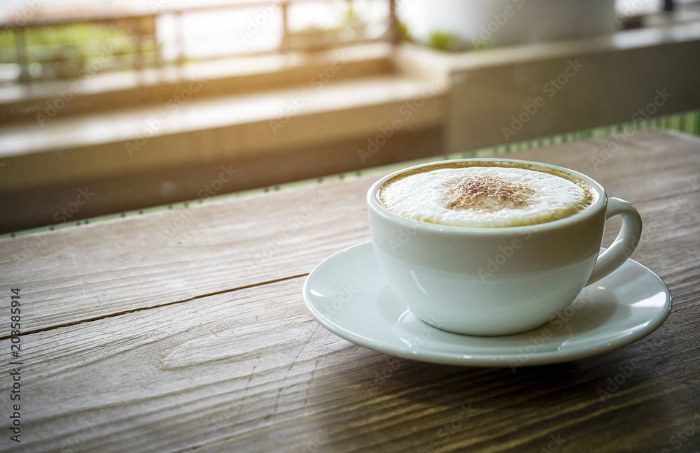 Obraz premium White cup of espresso coffee on wood table