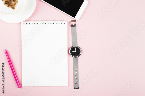 Concept morning planning - cappuccino, notebook, pen, phone, watch on pink background. Top view, copy space