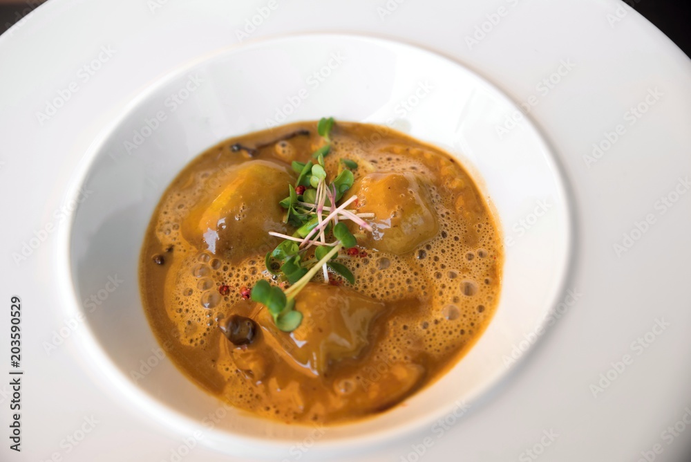 Oxtail ravioli in morel sauce. Oxtail ravioli in morel sauce.