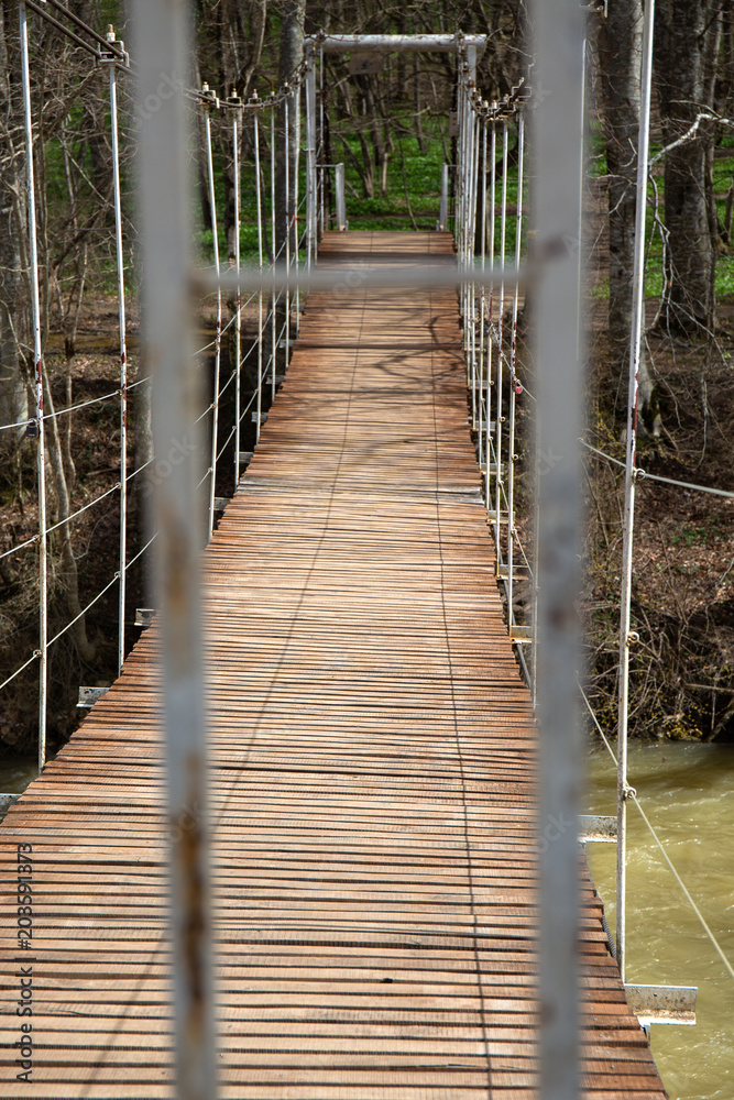 Fototapeta premium Suspended wooden bridge. the passage is closed on the bridge.