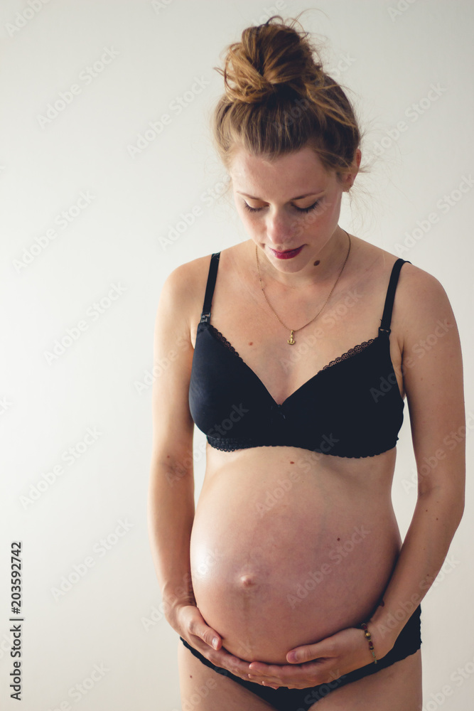 standing woman with big pregnant belly