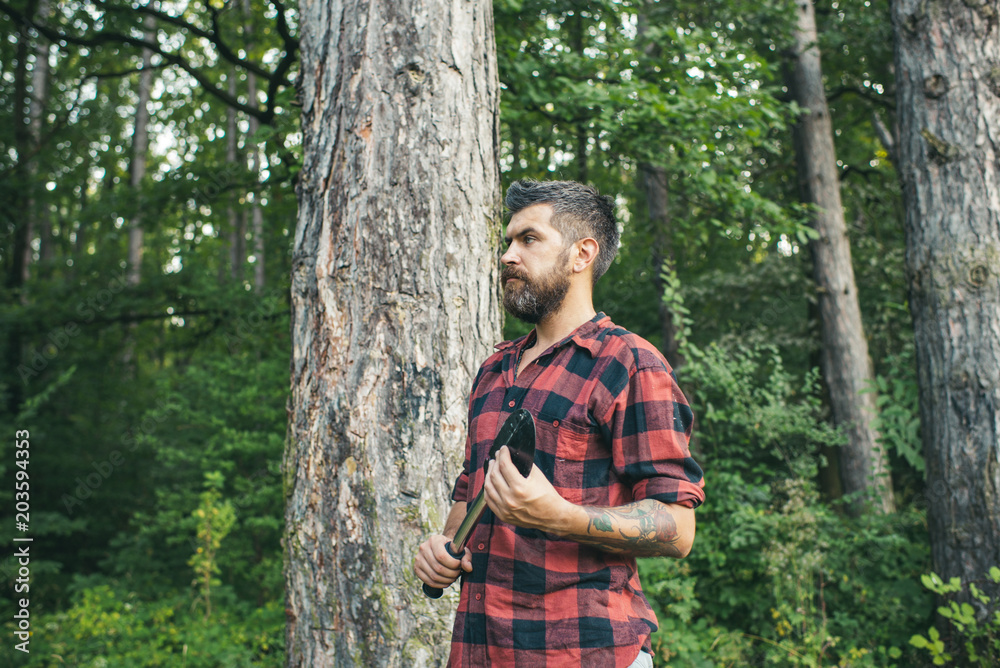 Bearded guy with spade wandering in woods. Side view brutal lumberjack waiting on path. Nature, camping, leisure concept Bearded guy with spade wandering in woods. Side view brutal lumberjack waiting on path. Nature, camping, leisure concept