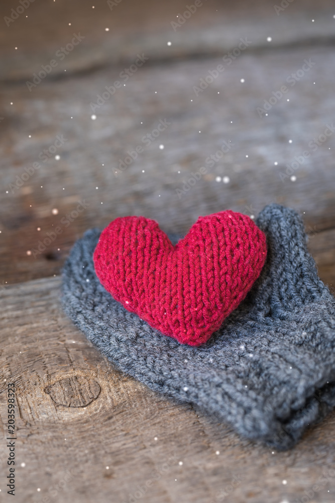 Knitted red heart on the handmade mitt, Valentine's Day postcard