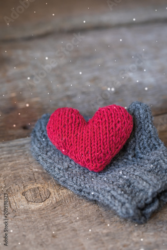 Knitted red heart on the handmade mitt  Valentine s Day postcard