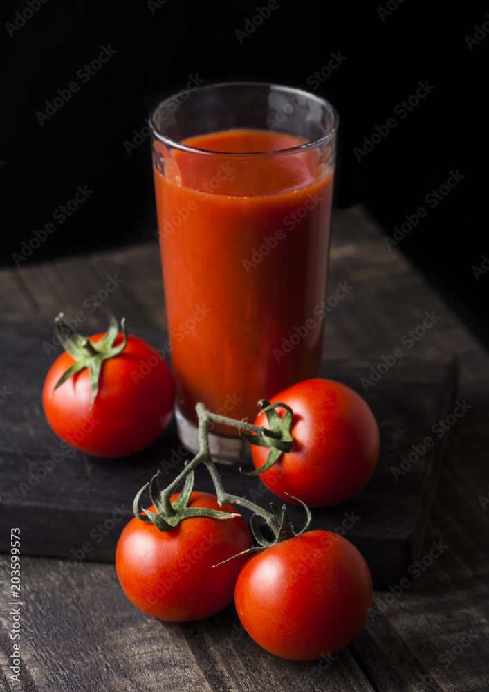 Glass of tomato juice with fresh raw tomatoes Glass of tomato juice with fresh raw tomatoes