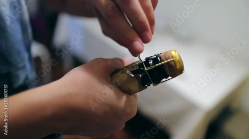 Close-up of hands opening a bottle of champagne2 photo