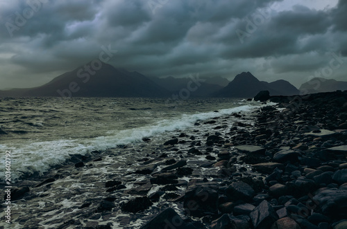 Dramatic landscape coastline view of rocks and Cullin hills, Scotland