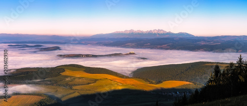 Panoramic landscape view of meadows, castle and mountain range, Slovakia