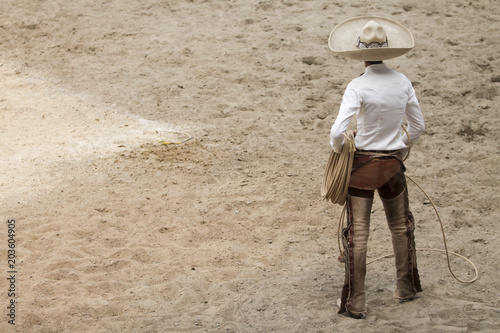 Mexican charro standing in the arena, charreria, mexican charro hat photo
