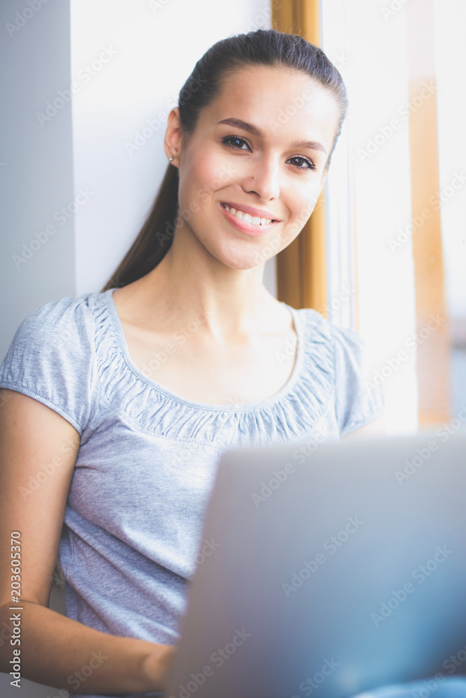 Young beautiful woman using a laptop computer at home. Young beautiful woman. Young beautiful woman using a laptop computer at home. Young beautiful woman.