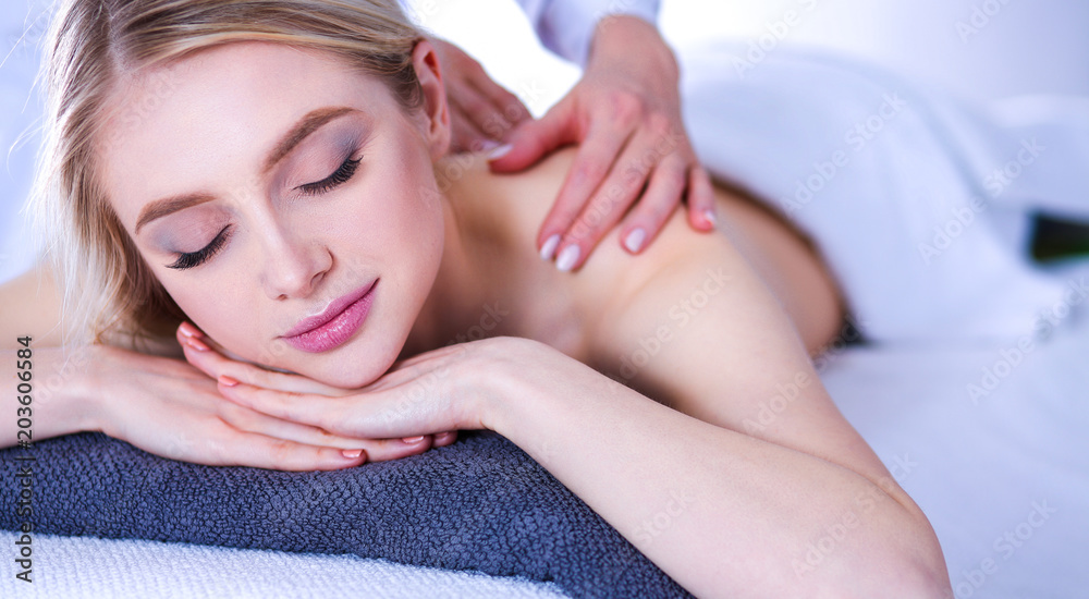 Young woman lying on a massage table,relaxing with eyes closed. Woman. Spa salon Young woman lying on a massage table,relaxing with eyes closed. Woman. Spa salon