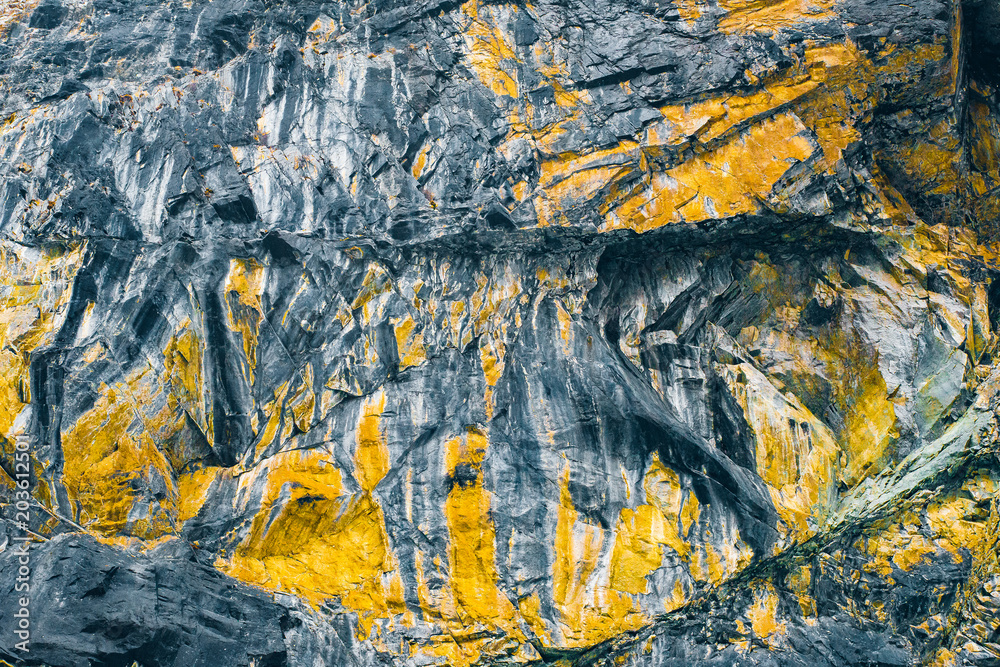 Macro texture cliffs. Yellow mountain worn rock background